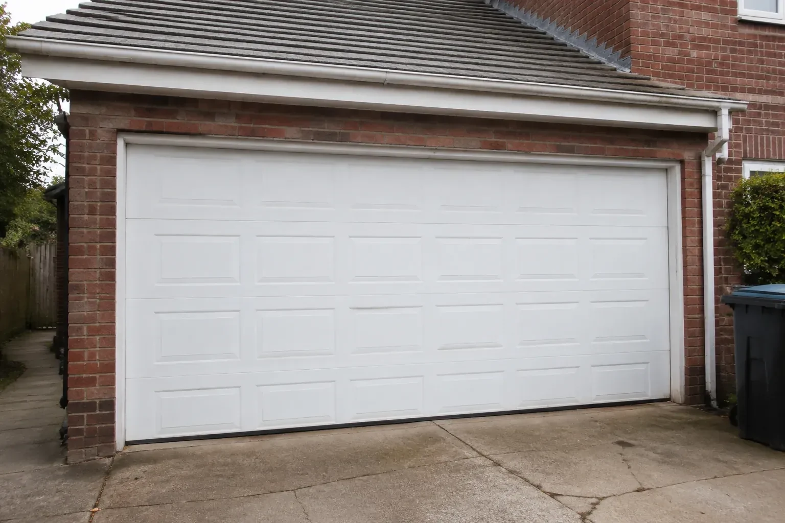 Closed white sectional garage door at an ordinary brick house. — Sectional Garage Door Replacement, Markham